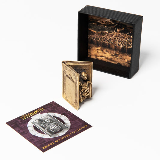 Bronze Miniature Character Book inspired by Jim Henson’s Labyrinth. Hand-finished sculpture of Sarah’s book with Ludo, Hoggle, and Sir Didymus depicted in stunning detail. Perfect for collectors and fans of the fantasy film.