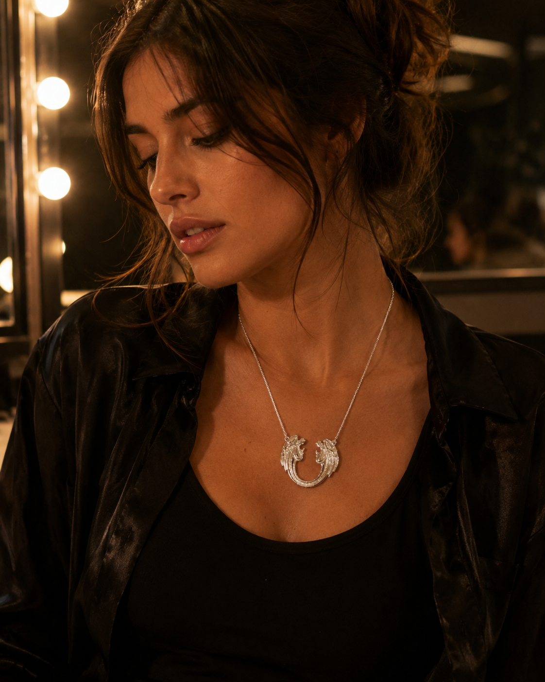 Close-up of the large sterling silver Jesus Christ Superstar pendant necklace worn on a 50cm chain, sitting naturally on the upper chest.