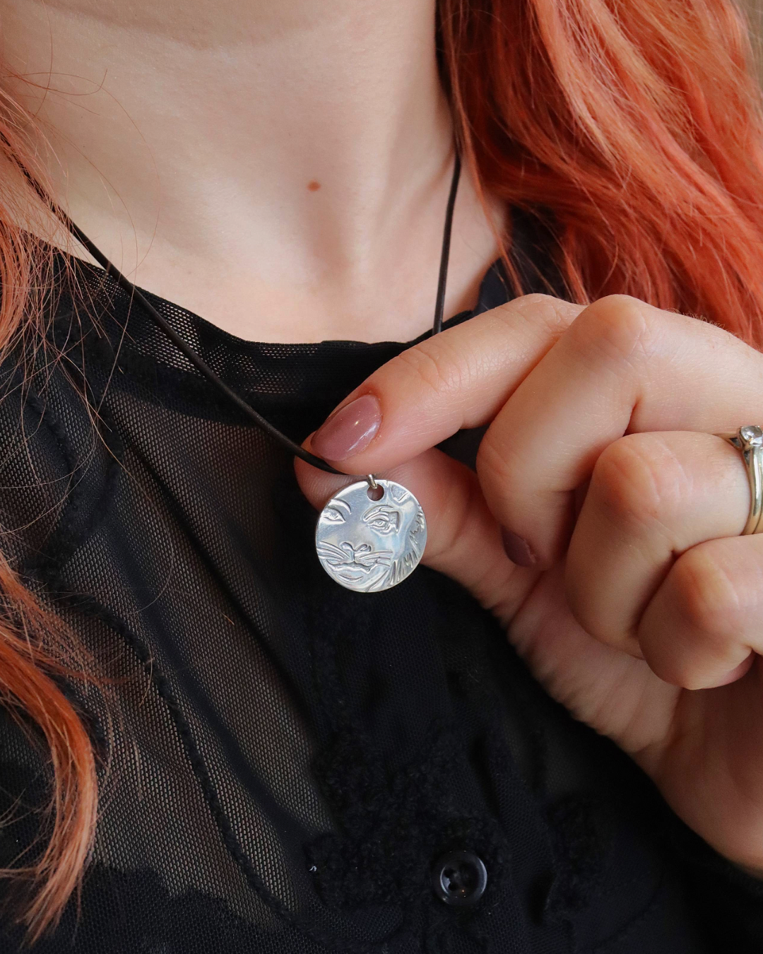 Model wearing the Licensed To Charm CATS Rum Tum Tugger leather necklace in silver plate