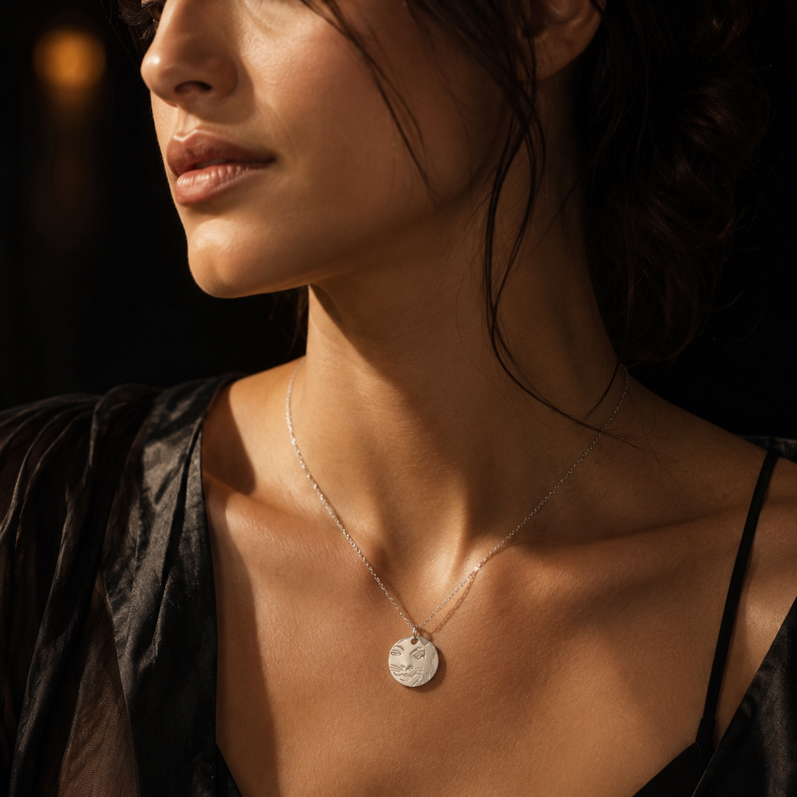 Close-up of model wearing the Licensed To Charm CATS Rum Tum Tugger necklace in silver plate