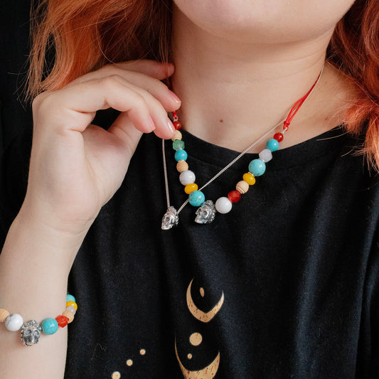 Model wearing Licensed To Charm Frida Kahlo Beaded Sugar Skull Cord Necklace with colourful beads and sterling silver sugar skull charm