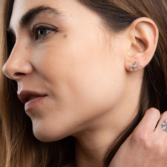 Model wearing Licensed To Charm Frida Kahlo Thorn Stud Earrings in sterling silver, styled as subtle gothic jewellery for art lovers