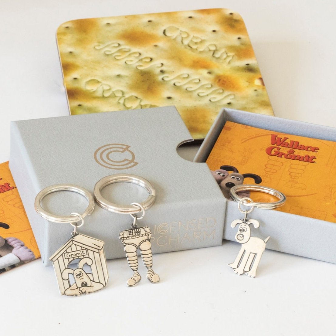 Licensed to Charm Gromit kennel silver keyring in a playful Wallace & Gromit gift flat lay