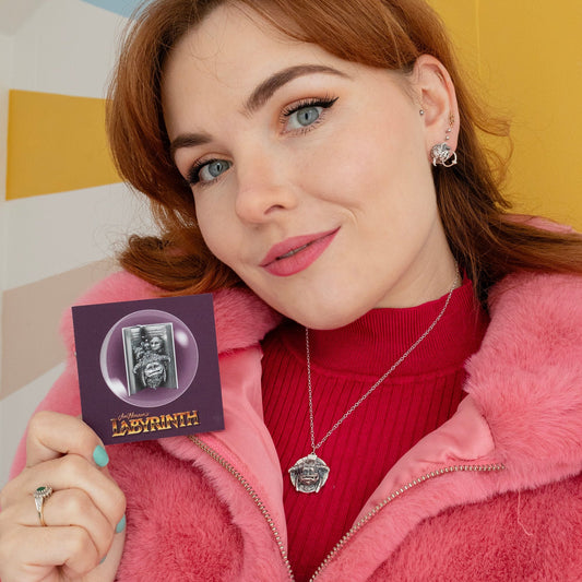 Licensed To Charm Labyrinth Ludo Necklace in sterling silver, pendant held in hand to show detailed design, handmade jewellery gift.