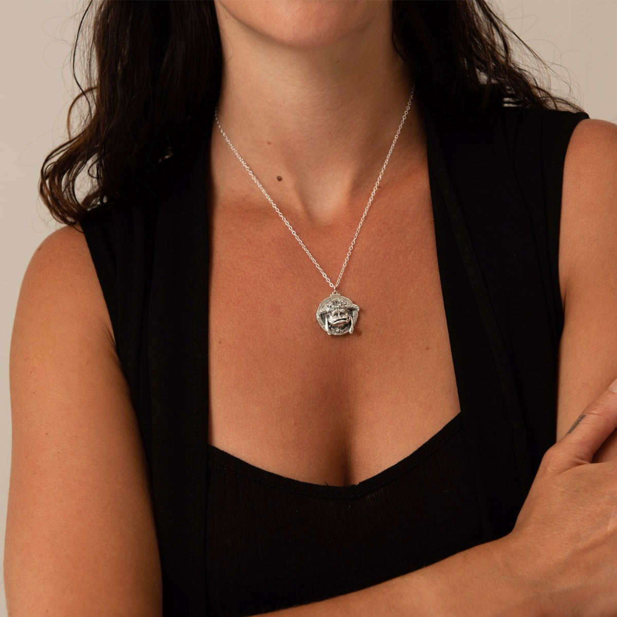 Licensed To Charm Labyrinth Ludo Necklace in sterling silver, pendant held in hand to show detailed design, handmade jewellery gift.