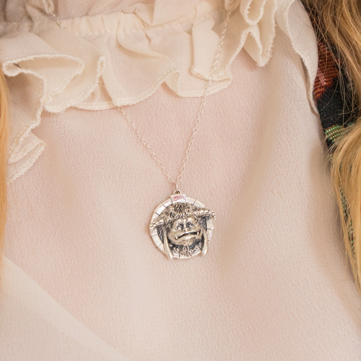 Licensed To Charm Labyrinth Ludo sterling silver necklace displayed on fabric background, officially licensed Labyrinth jewellery gift.