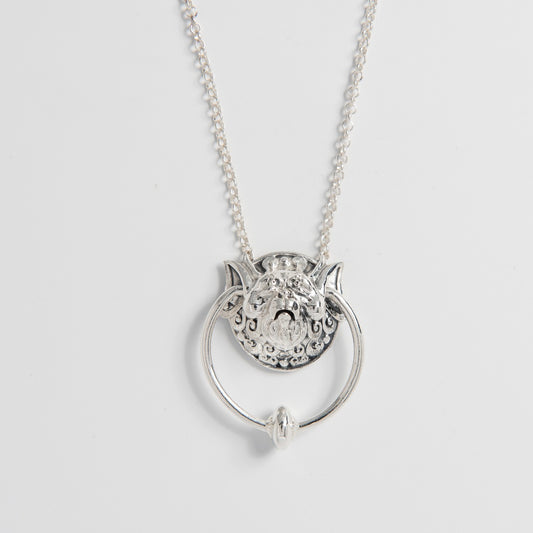 Sterling Silver Right Door Knocker Necklace from Jim Henson’s Labyrinth. Features the iconic, eccentric right door knocker with a movable ring through his ears, intricately handcrafted from sustainable sterling silver. A whimsical tribute for fans of the classic film