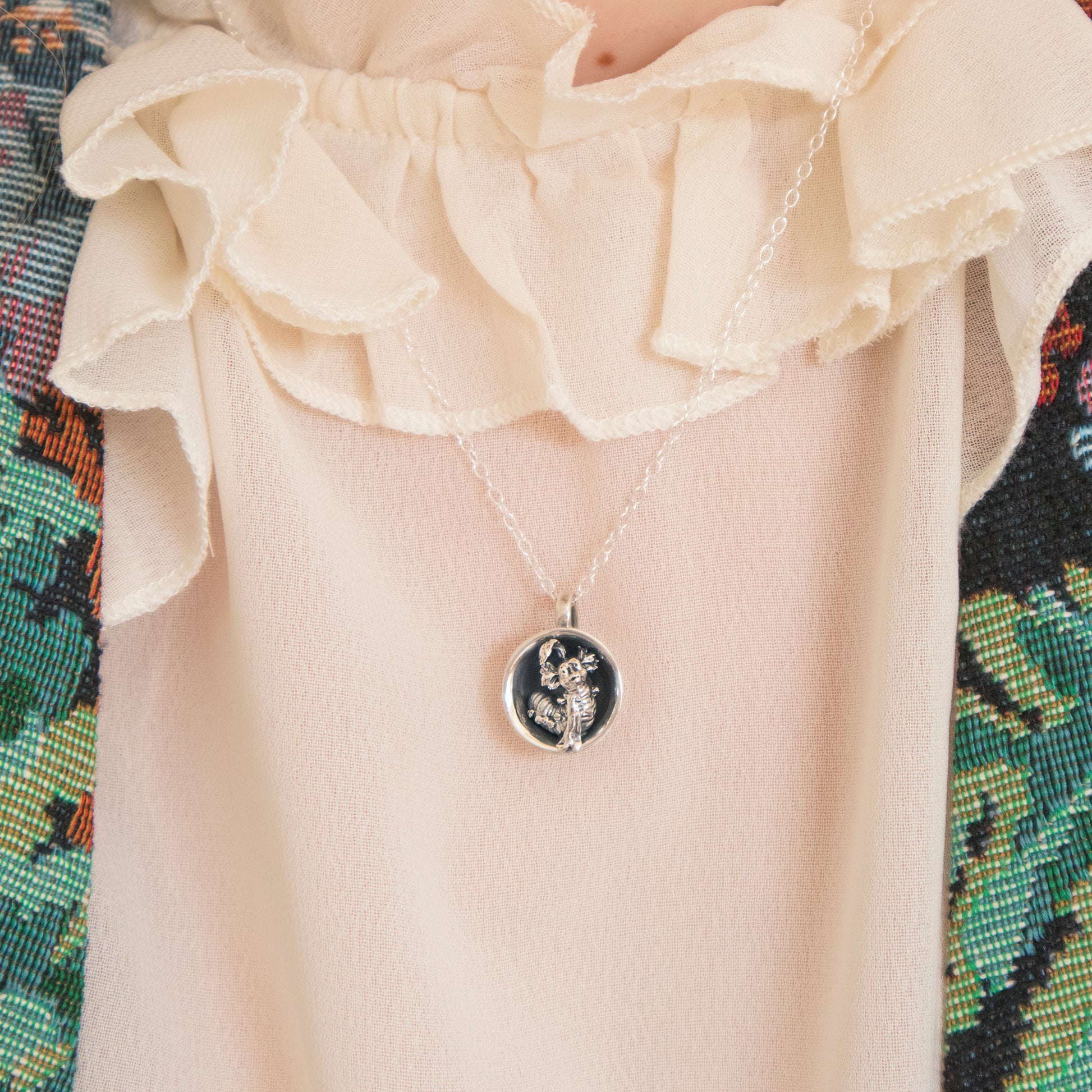 Licensed To Charm Labyrinth Worm in a Cup Necklace styled on model, sterling silver handmade gift.