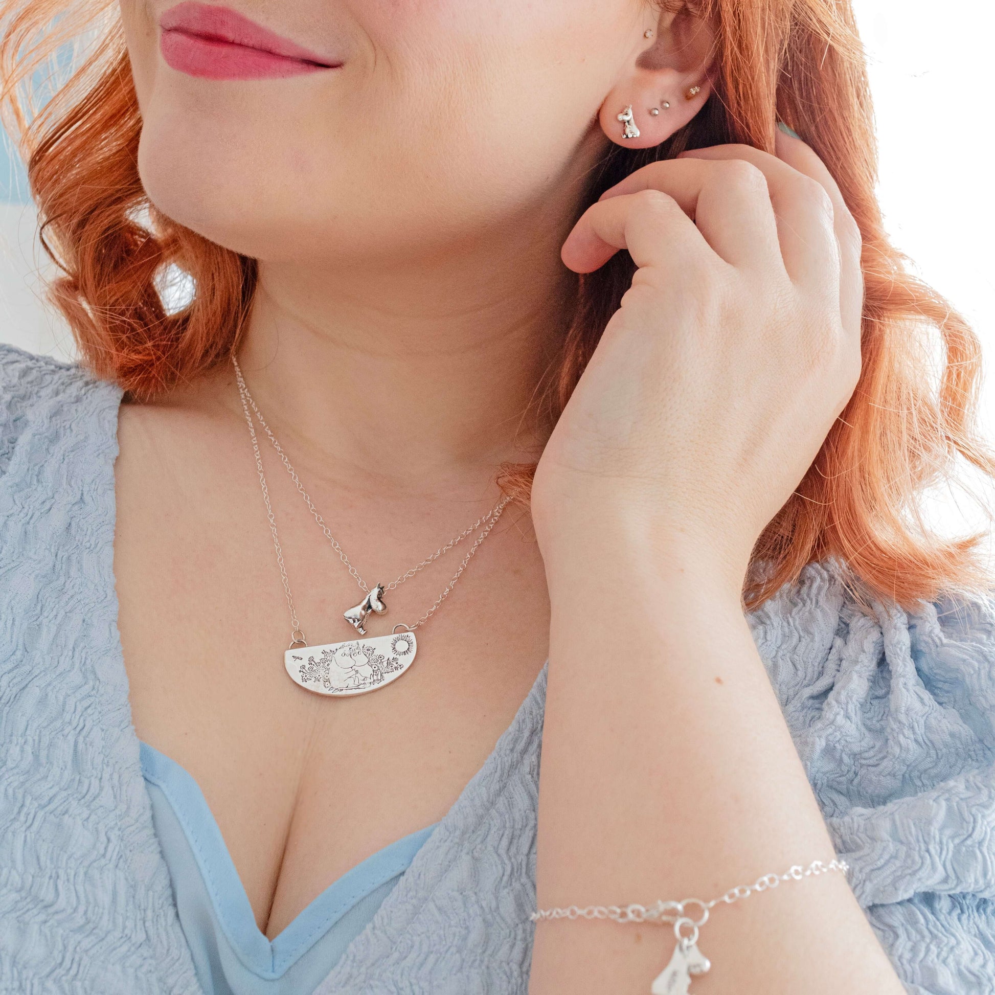 Close-up of woman wearing the Licensed To Charm Moomin Friends Among Flowers Necklace in sterling silver