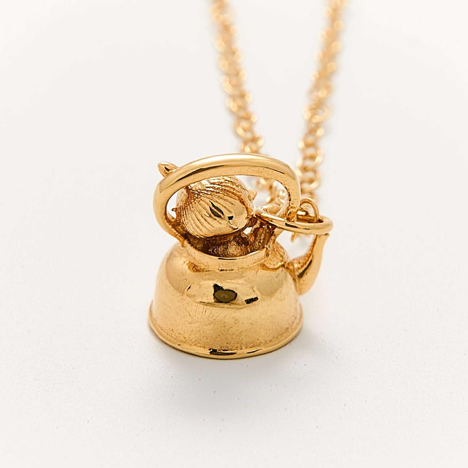 Close-up of Licensed To Charm Moomin Little My gold vermeil necklace charm, detailed Little My sitting in teapot design