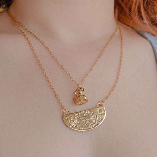 Licensed To Charm Moomin Little My gold vermeil necklace worn layered on model, featuring Little My charm and engraved pendant detail