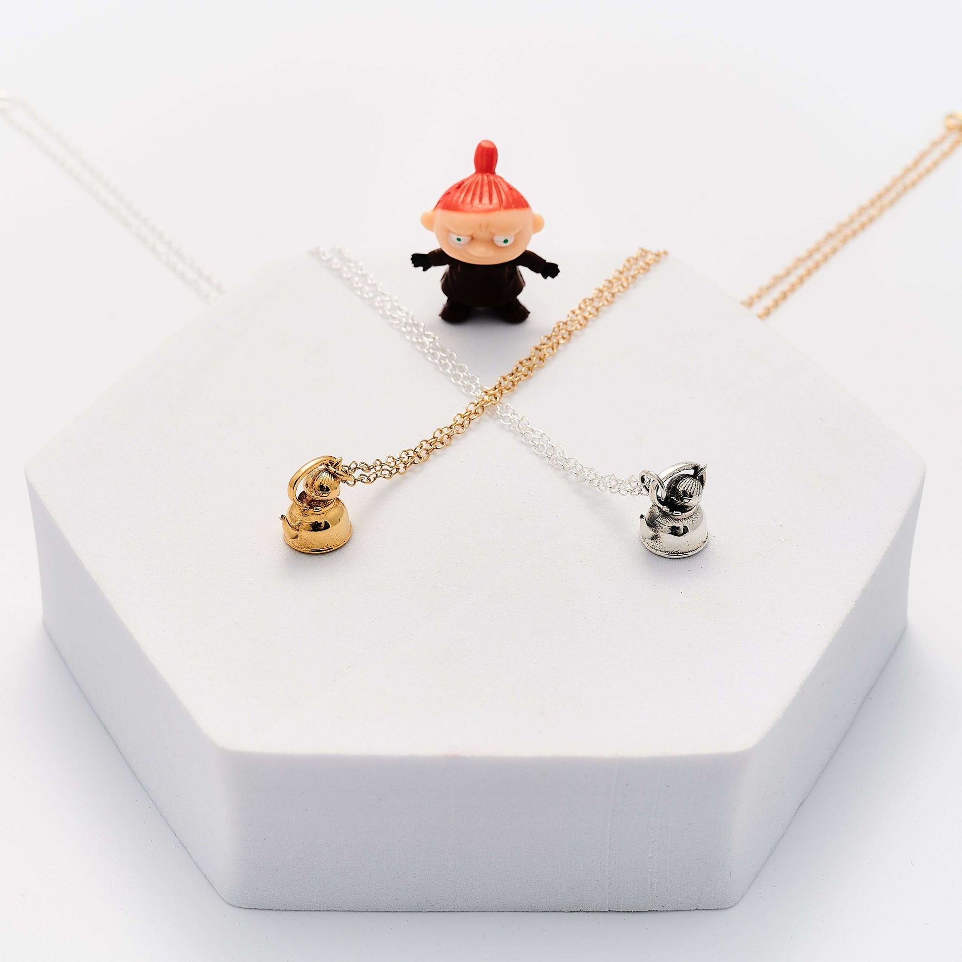 Licensed To Charm Moomin Little My necklaces in gold vermeil and sterling silver displayed together with Little My character figure