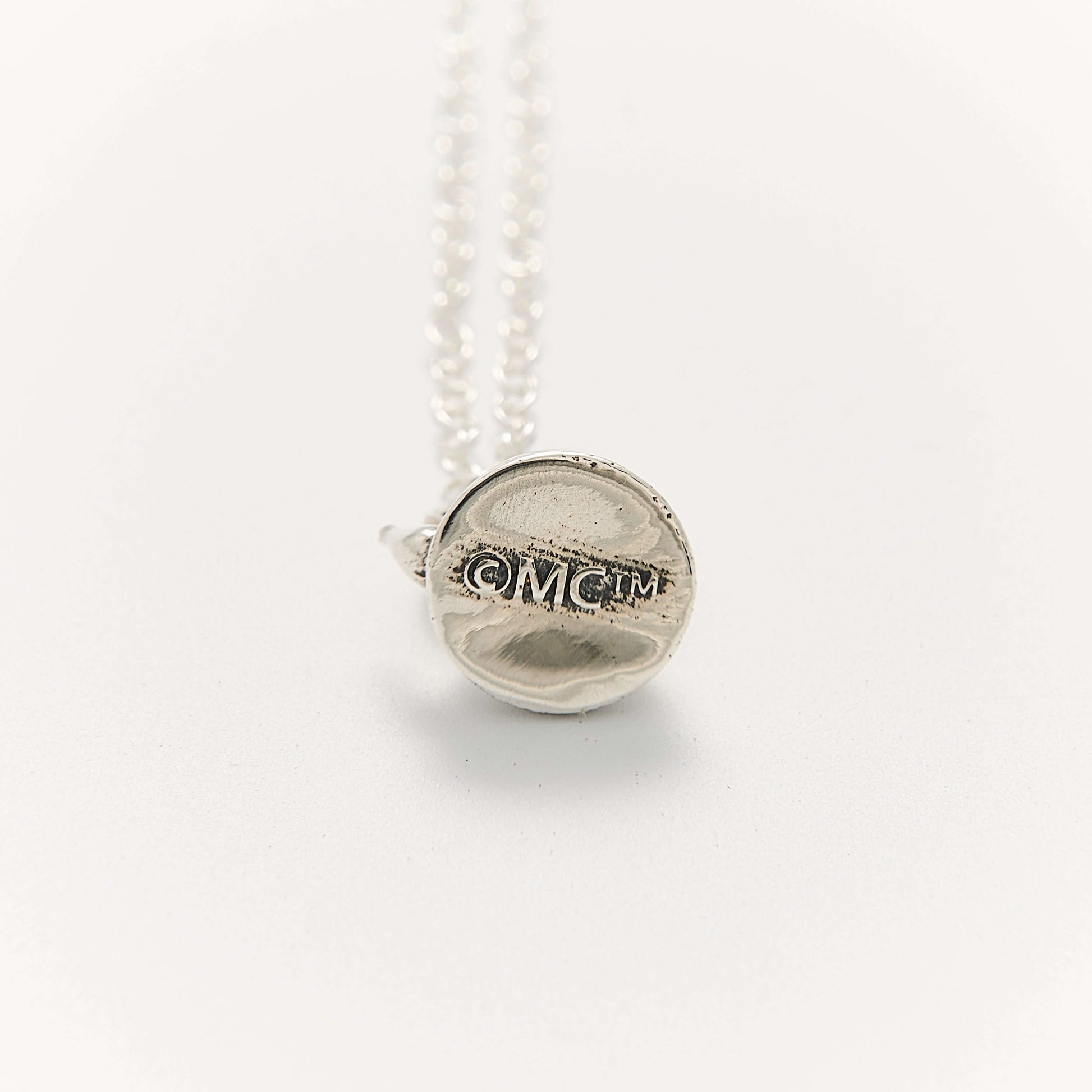Close-up of the Moomin Little My Necklace in sterling silver by Licensed To Charm from a different angle