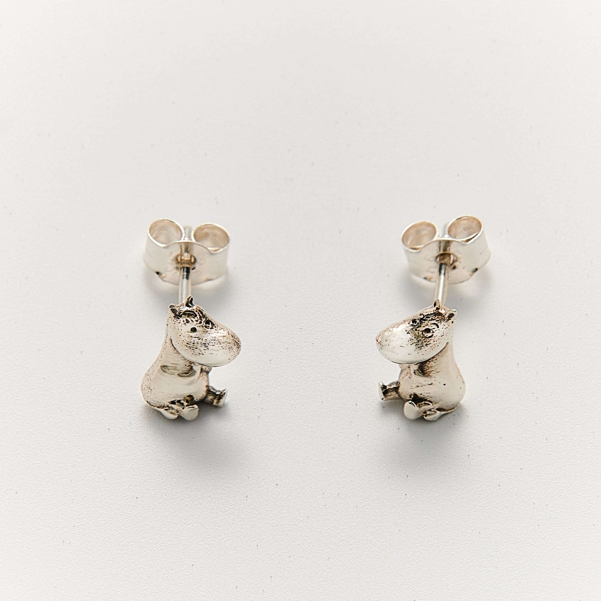 Close-up of Licensed To Charm Moomin Stud Earrings in sterling silver showing Moomintroll and Snorkmaiden
