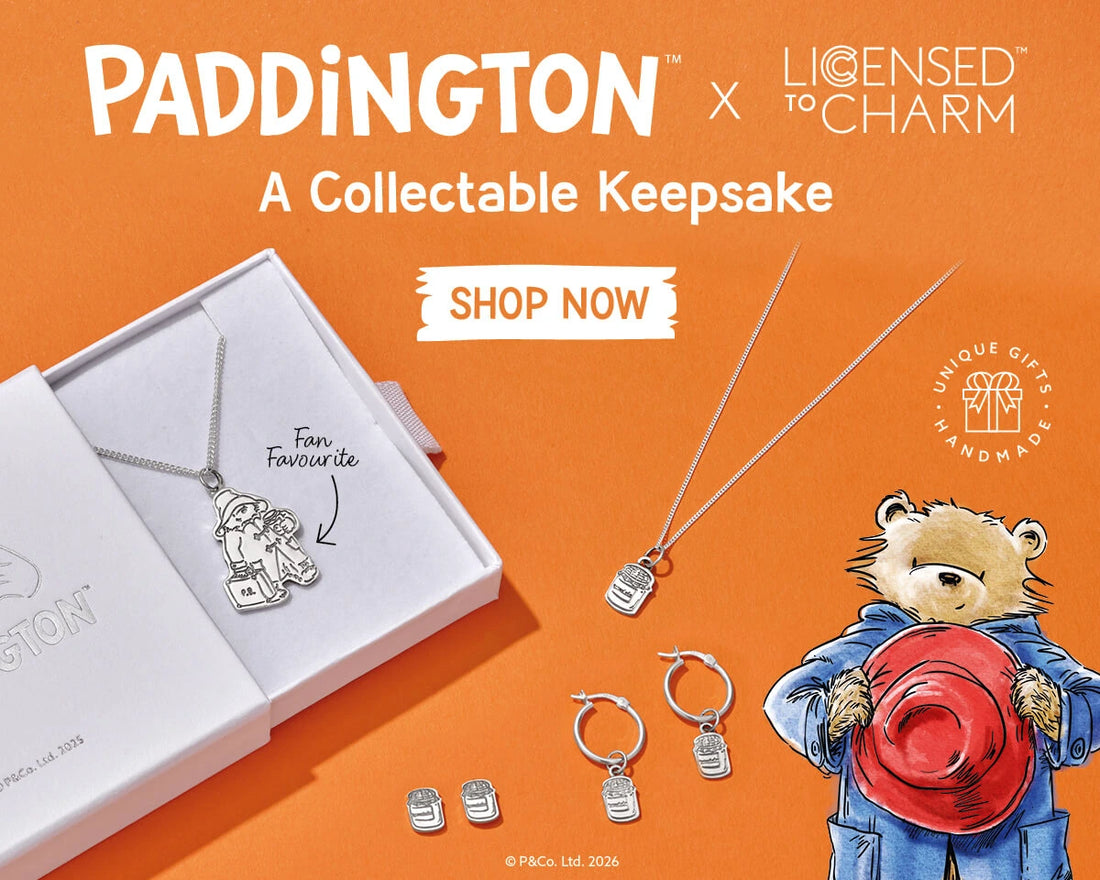 Licensed To Charm officially licensed Paddington Bear collectable keepsake jewellery banner featuring sterling silver necklace, hoop earrings and gift box on an orange background