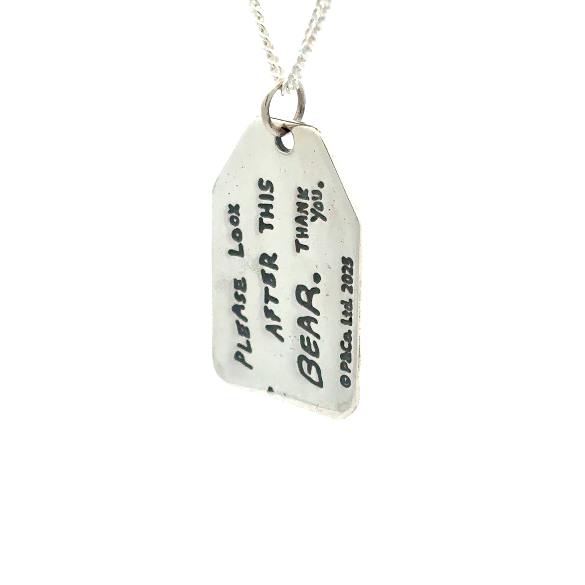 Licensed To Charm Reversible Paddington pendant showing quote side — “Please look after this bear. Thank you.”