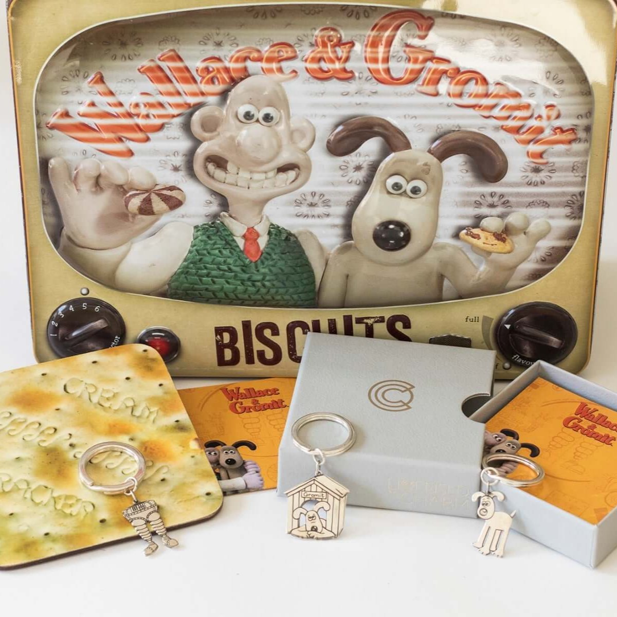 Licensed to Charm Wallace & Gromit Wrong Trousers keyring displayed with film artwork and gift props