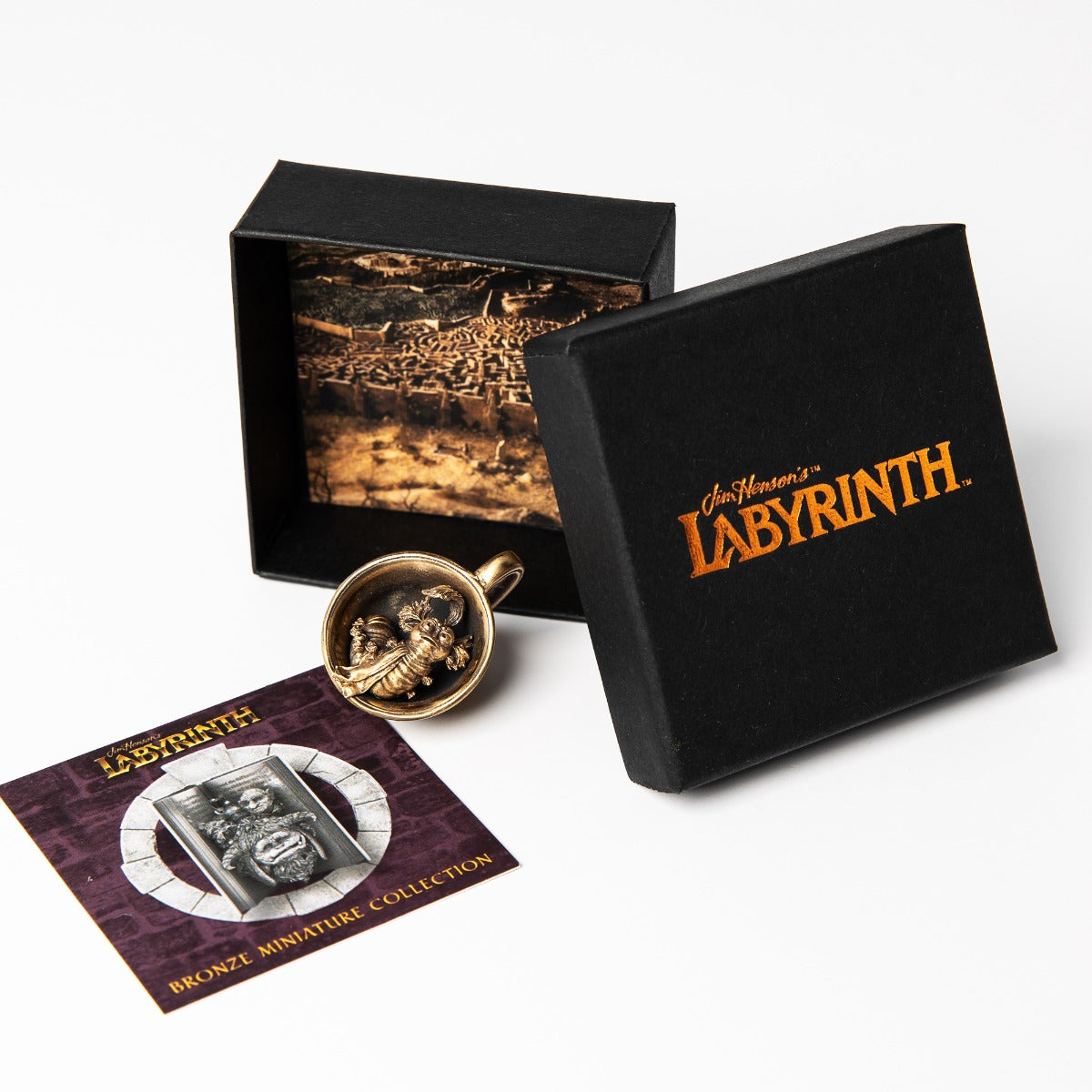 Licensed To Charm Bronze Worm in a Cup Miniature from Jim Henson’s Labyrinth. Detailed sculpture of the iconic Worm character sitting in a teacup, finished with an antique patina. Perfect collectable for Labyrinth enthusiasts or a nostalgic gift.