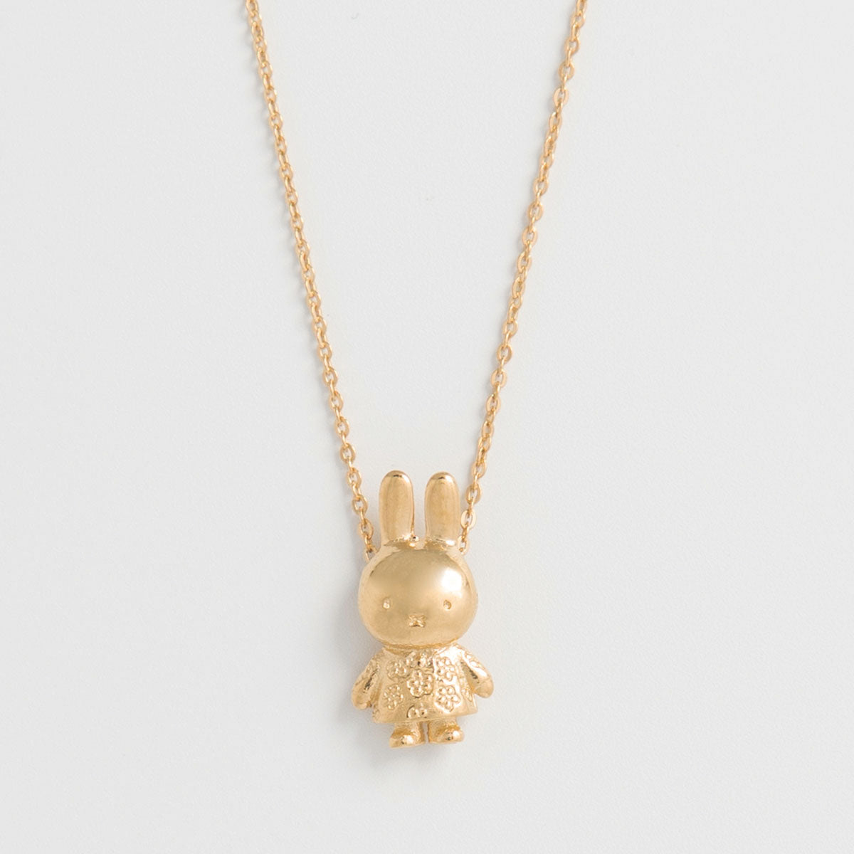 Miffy Daisy Charm Necklace in 18ct gold vermeil, featuring a 3D Miffy in a daisy-patterned dress. A playful and charming gift for Miffy fans.