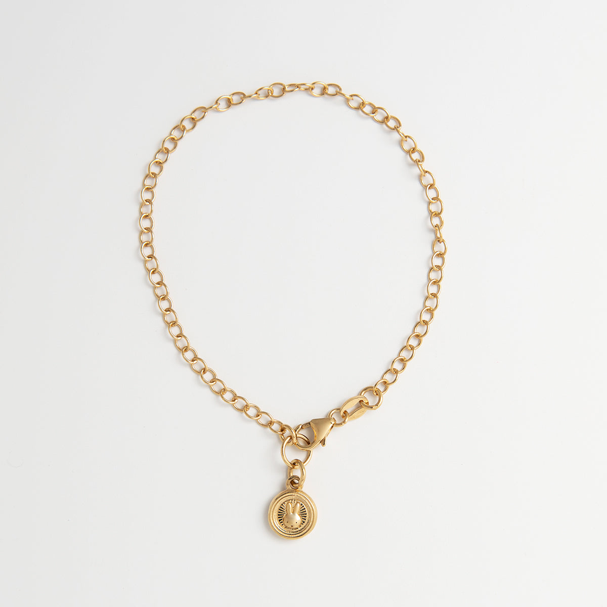 Close-up of Miffy Mini Coin Charm Bracelet in 18ct Gold Vermeil, featuring Miffy’s face in an intricate Chinese-style pattern on a dainty chain.