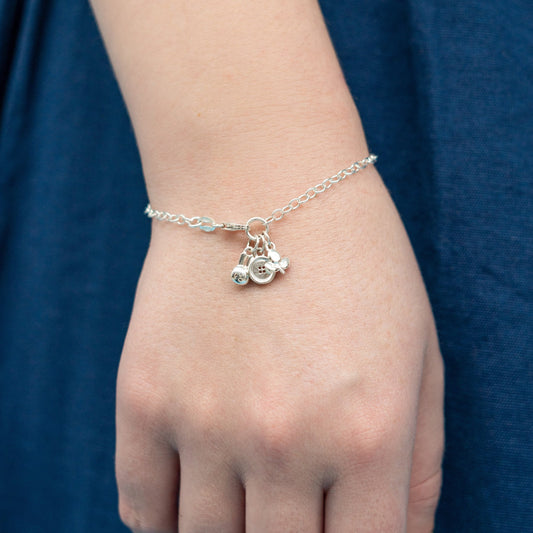 Miffy Charm Bracelet displayed on a wrist, highlighting its recycled sterling silver finish and playful Miffy-themed charms.