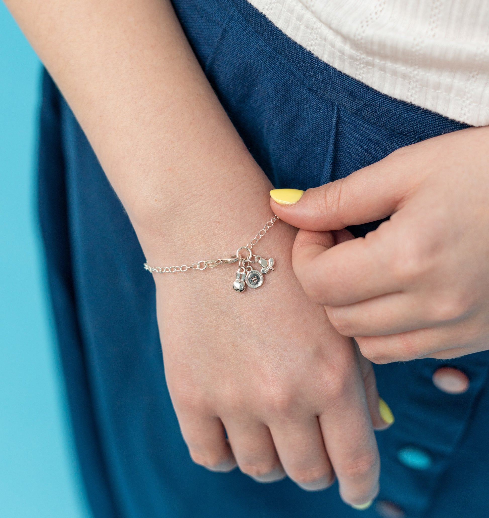 Recycled sterling silver Miffy Charm Bracelet with three delightful charms: Miffy head, button, and tulip. A thoughtful gift for special occasions.