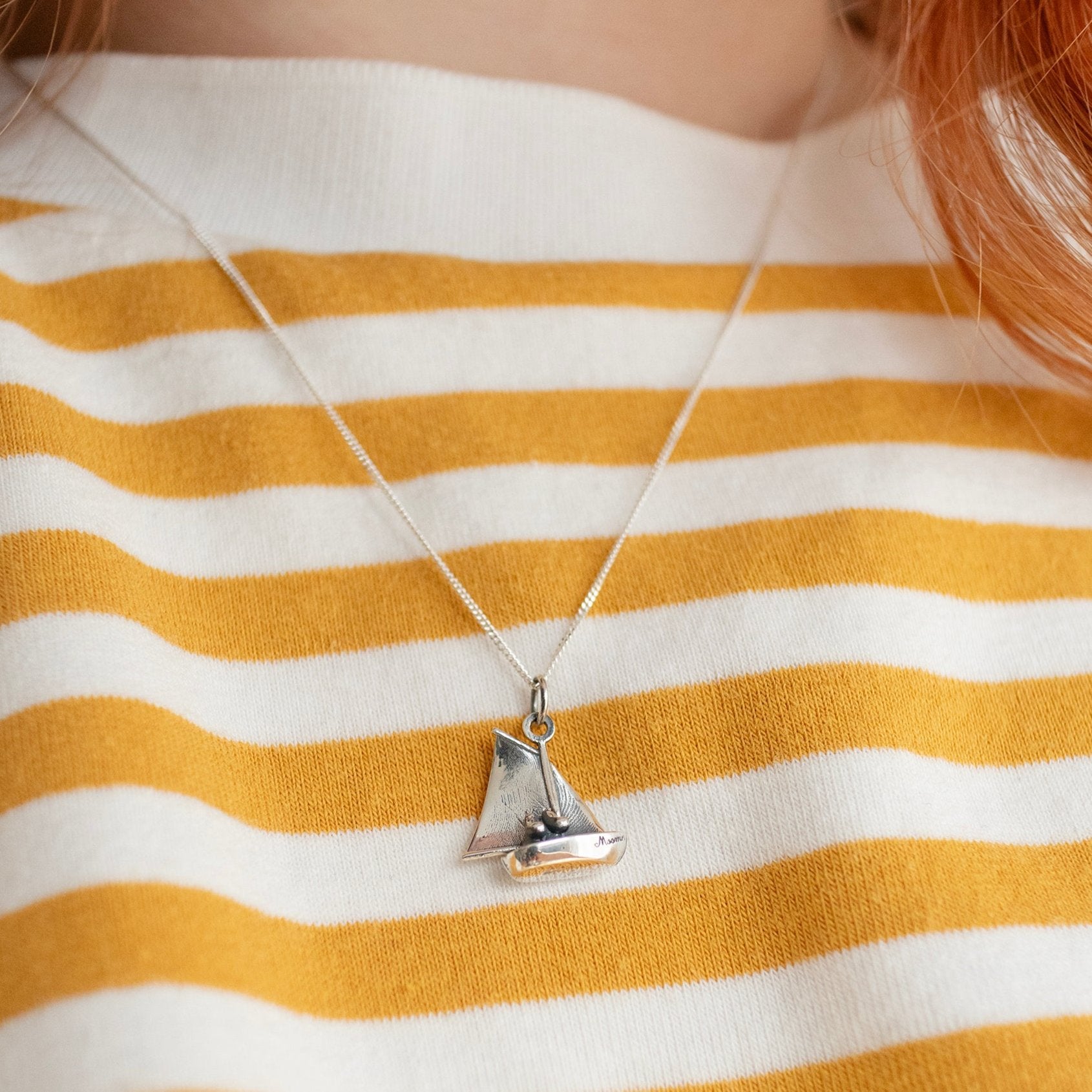 Sterling silver Moomin Sailing Boat Necklace on a 45 cm trace chain, featuring Moomintroll and Snorkmaiden seated in a tiny boat