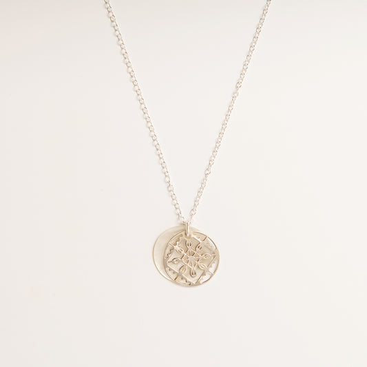 Front-facing view of the Lace Mother of Pearl Necklace in sterling silver, featuring a double-disc pendant with intricate lace detailing and mother-of-pearl.