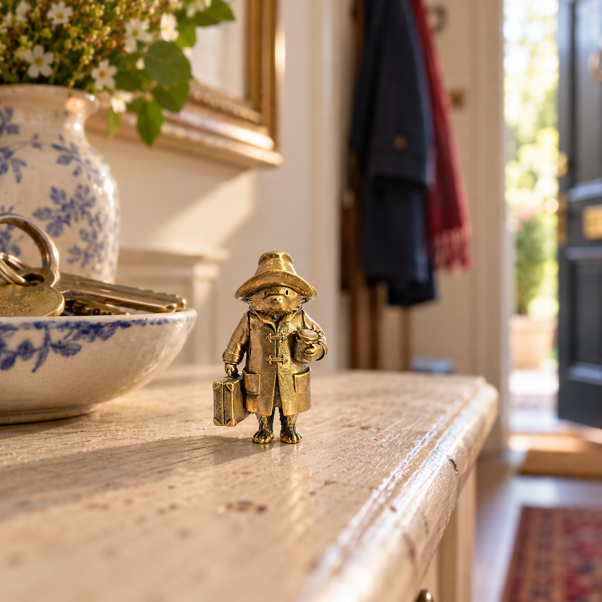 Paddington Bear miniature bronze figurine displayed on a hallway table beside house keys