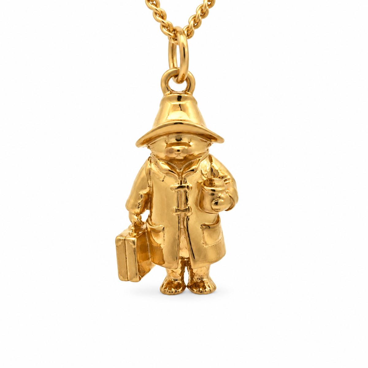 Close-up of the 18ct gold vermeil Paddington necklace showing the miniature full-body pendant with detailed hat, coat and suitcase