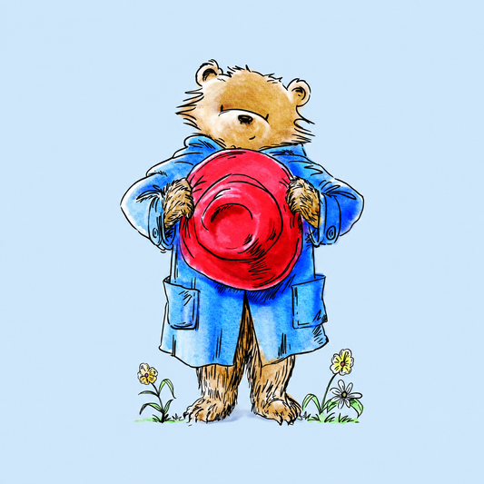 A illustration of Paddington bear wearing a blue coat and holding a large red hat in front of its face, with small flowers at the bottom, on a light blue background.