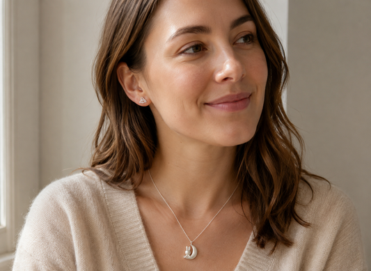 Woman wearing Paddington stud earrings and a Miffy & The Moon sterling silver necklace