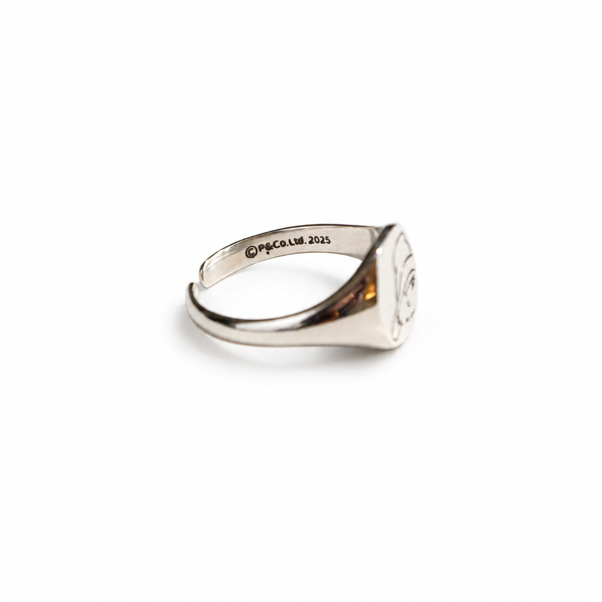 Side view of the Paddington adjustable sterling silver signet ring, showing its polished finish and band.