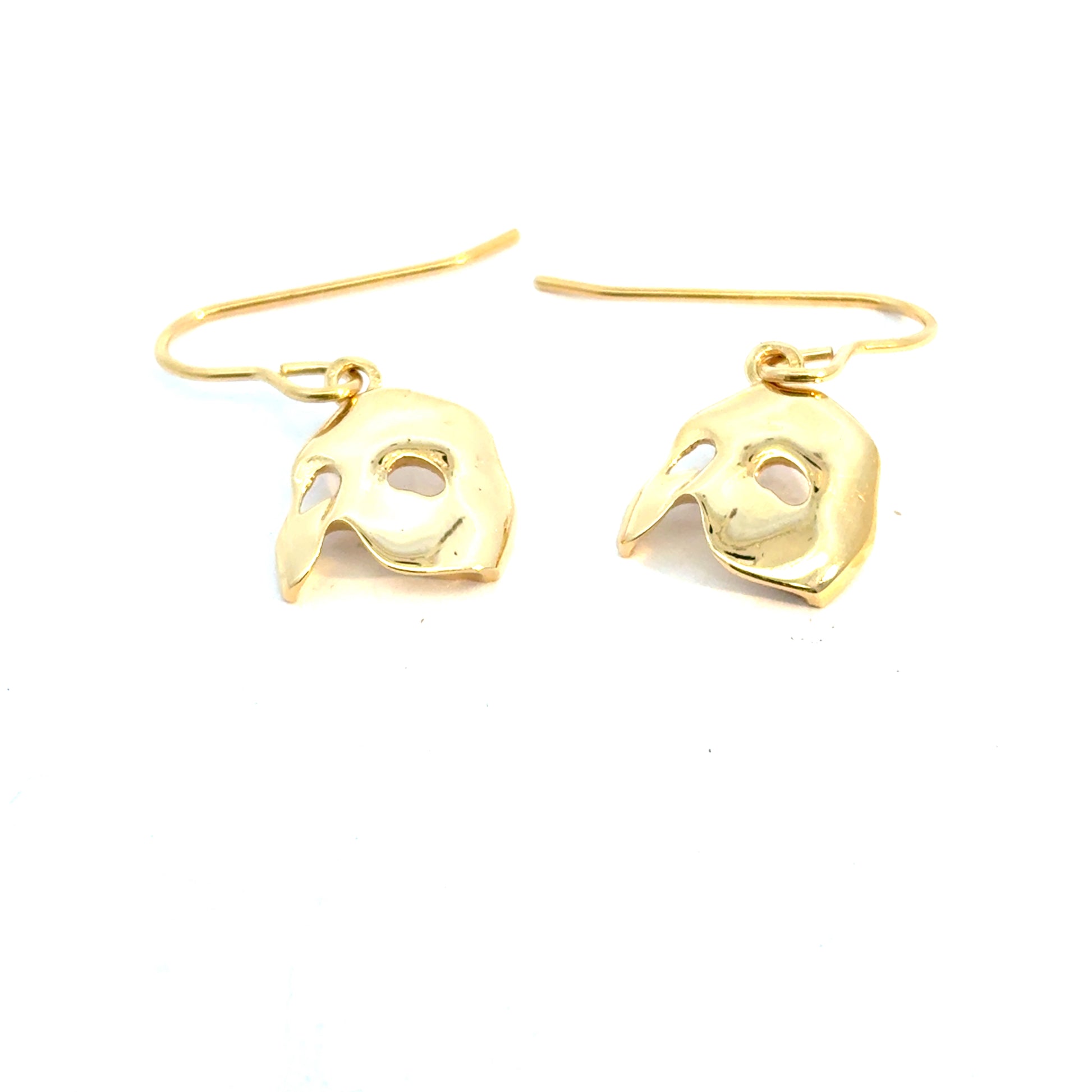 Detailed angled view of Phantom large mask drop earrings in gold vermeil