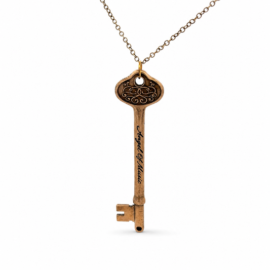 Phantom of the Opera bronze Angel of Music key necklace on an antique bronze chain, photographed on a white background.