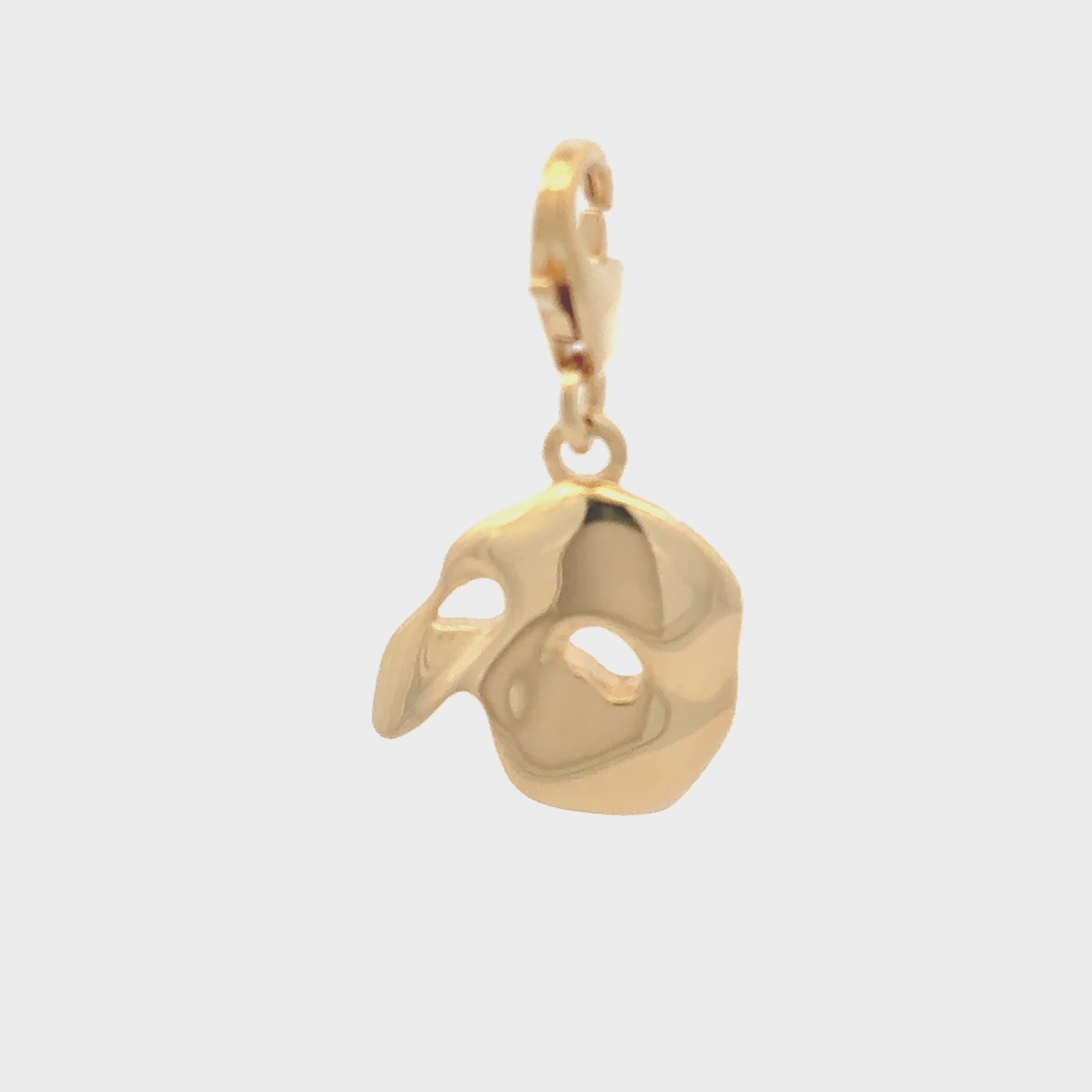 Licensed To Charm 360 turnaround close-up of gold vermeil Phantom mask charm showing polished sculpted detail