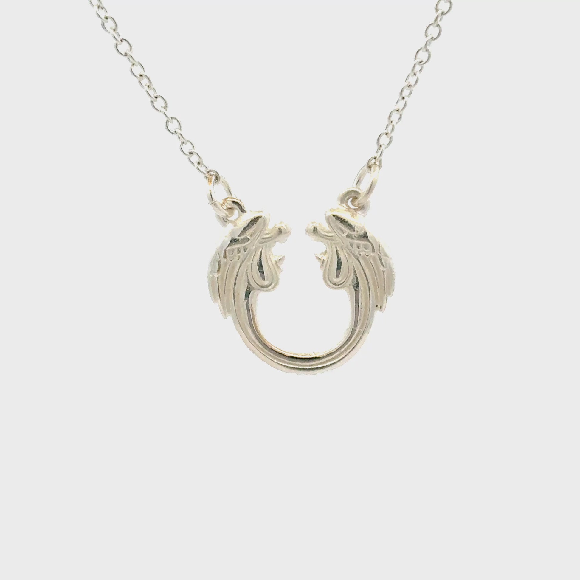 Close-up of Jesus Christ Superstar sterling silver pendant necklace inspired by the iconic musical logo.