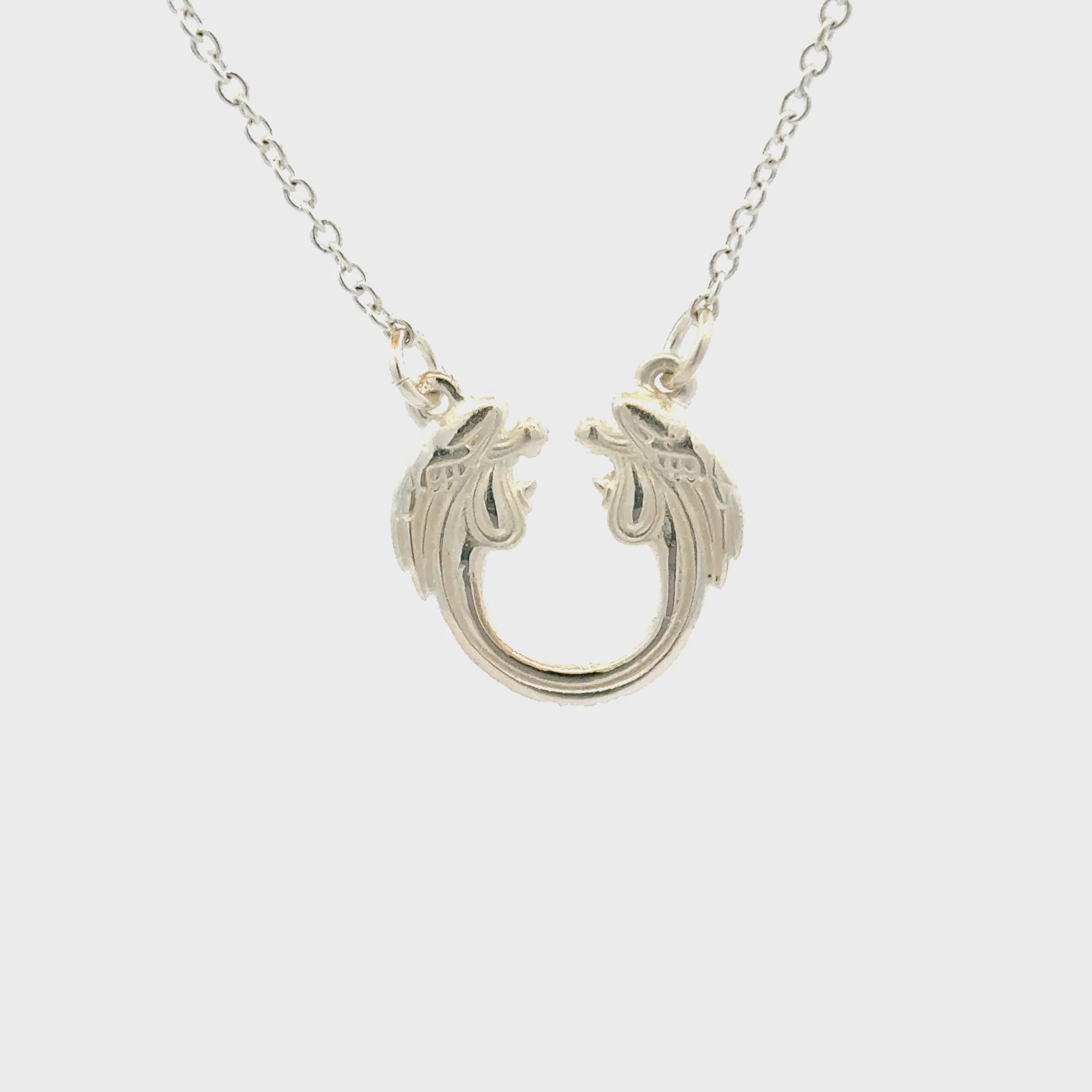 Close-up of Jesus Christ Superstar sterling silver pendant necklace inspired by the iconic musical logo.