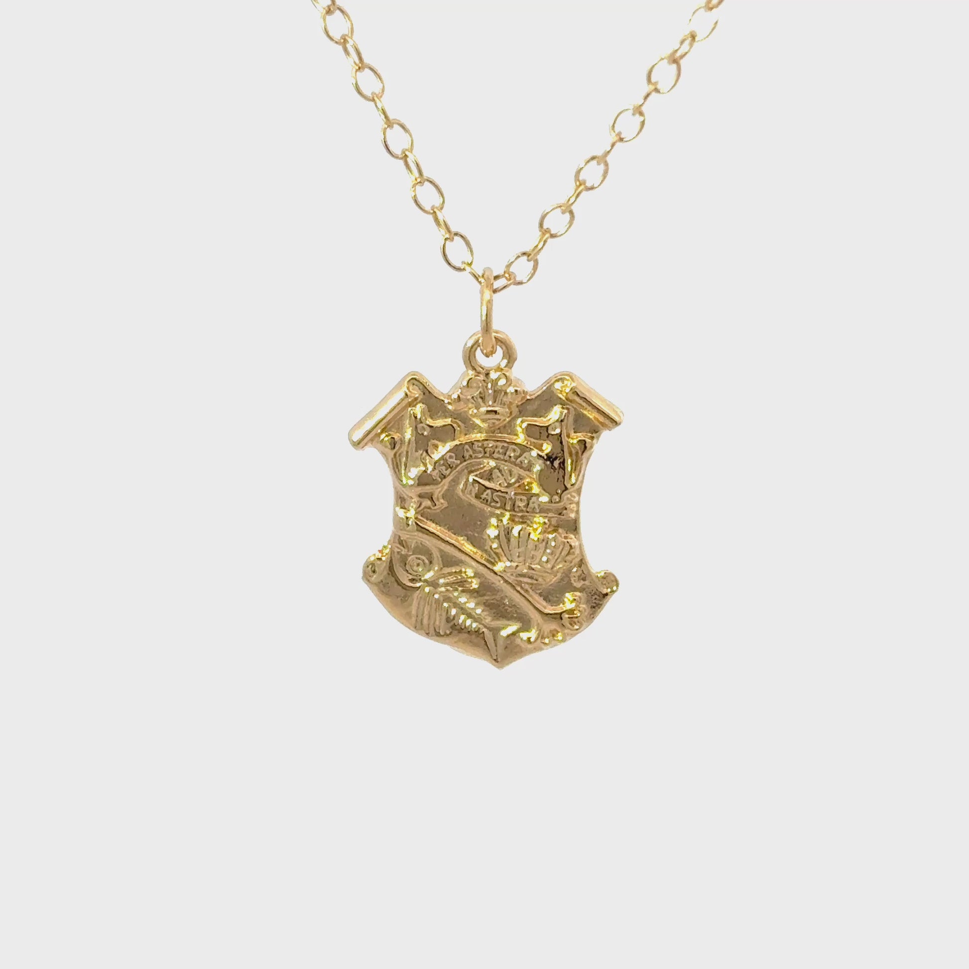 licensed to charm Close-up  turnaround video of the gold vermeil Moomin Crest pendant showing detailed engraving and polished finish