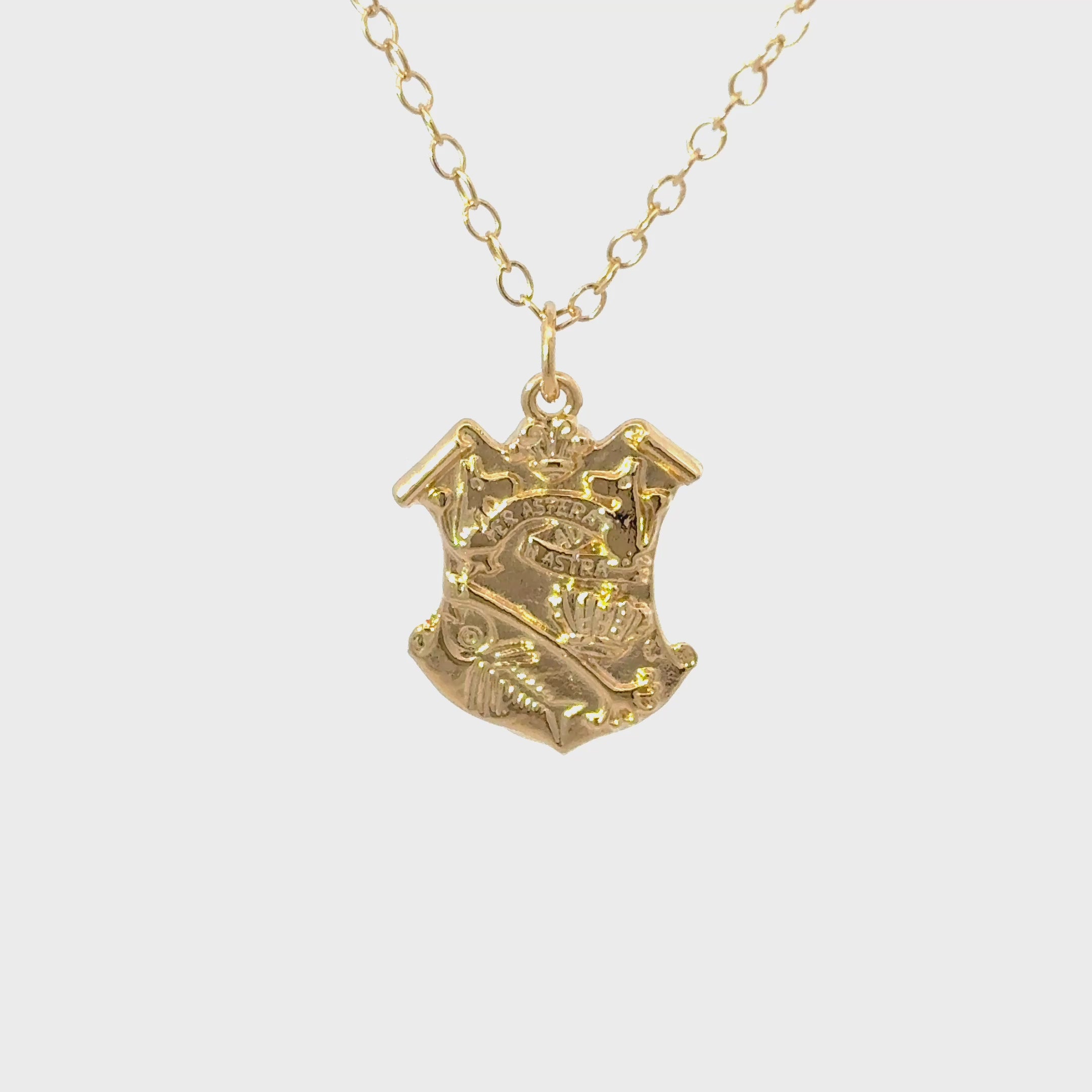 licensed to charm Close-up  turnaround video of the gold vermeil Moomin Crest pendant showing detailed engraving and polished finish