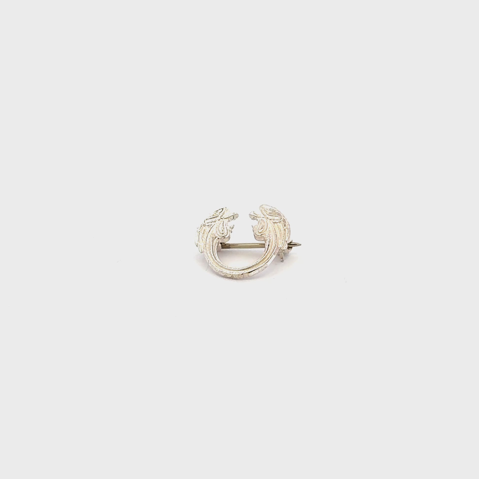Jesus Christ Superstar silver plated lapel pin brooch flat view video turnaround, official Andrew Lloyd Webber theatre accessory handmade in the UK.