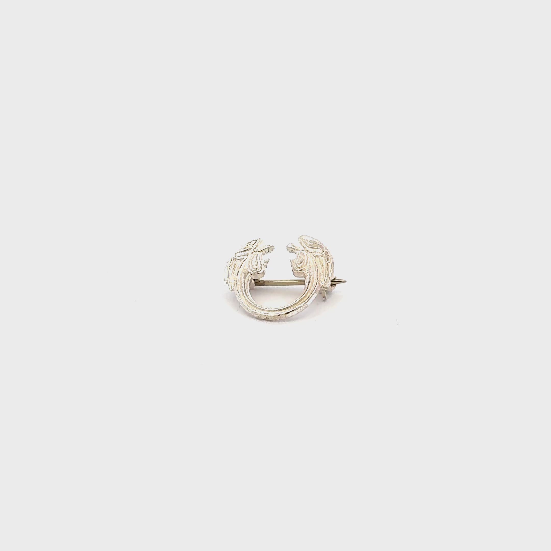Jesus Christ Superstar silver plated lapel pin brooch flat view video turnaround, official Andrew Lloyd Webber theatre accessory handmade in the UK.