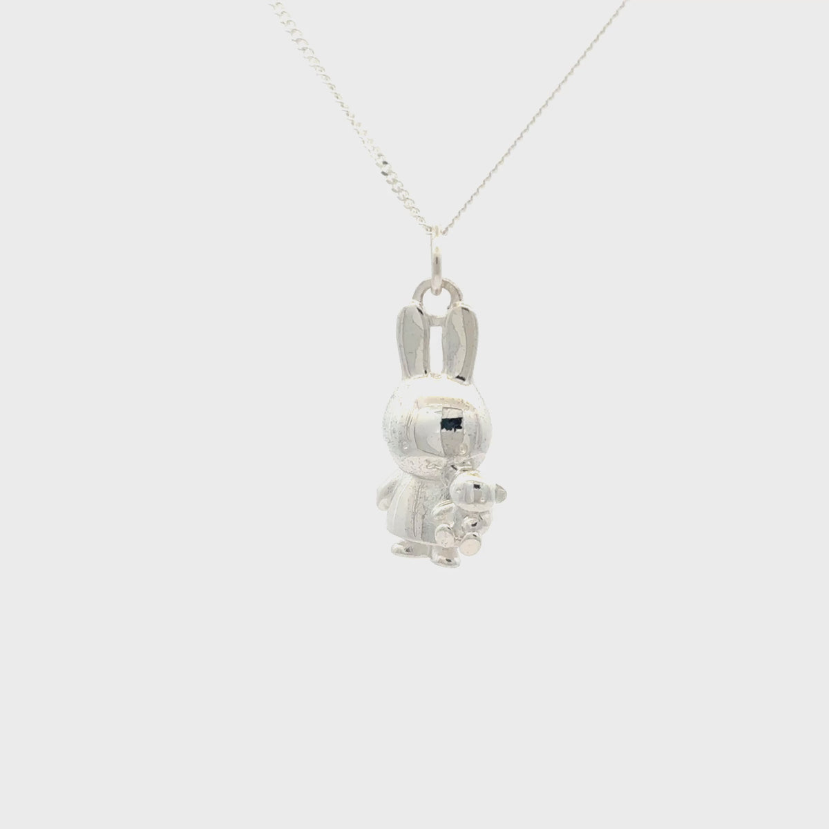 Sterling silver Miffy Holding Teddy Necklace video turnaround featuring a detailed Miffy bunny pendant cuddling her little teddy bear on a silver chain.