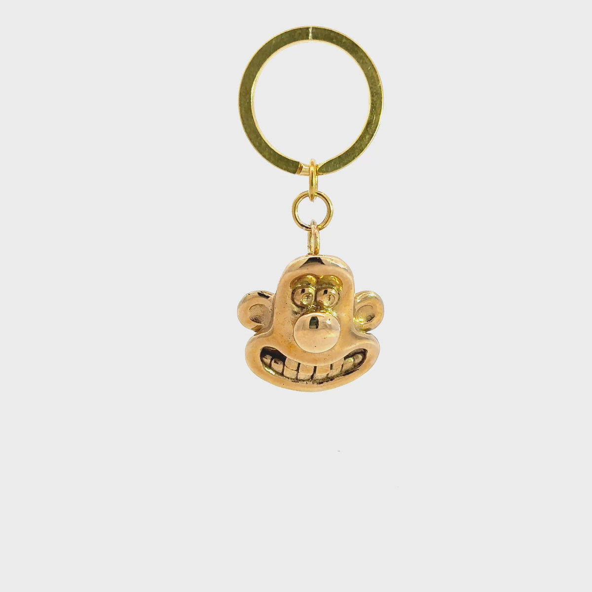 Licensed to Charm Wallace 3D head brass keyring from Wallace & Gromit on a white background turnaround video