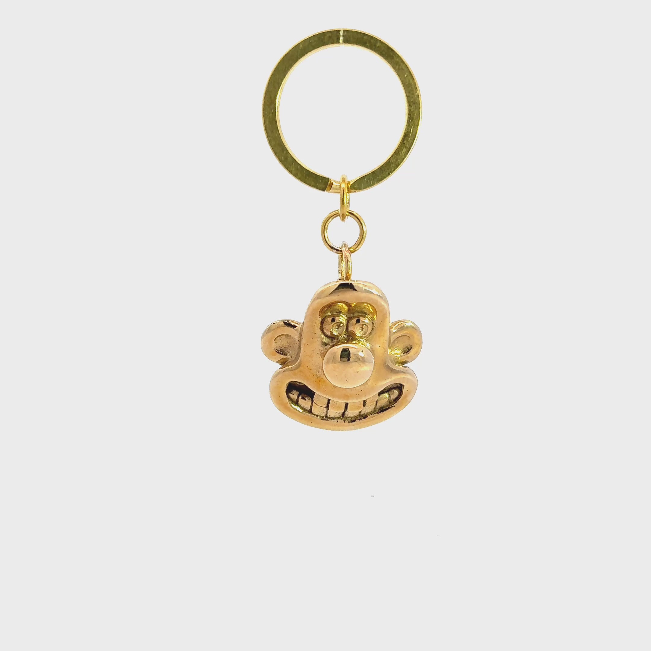 Licensed to Charm Wallace 3D head brass keyring from Wallace & Gromit on a white background turnaround video