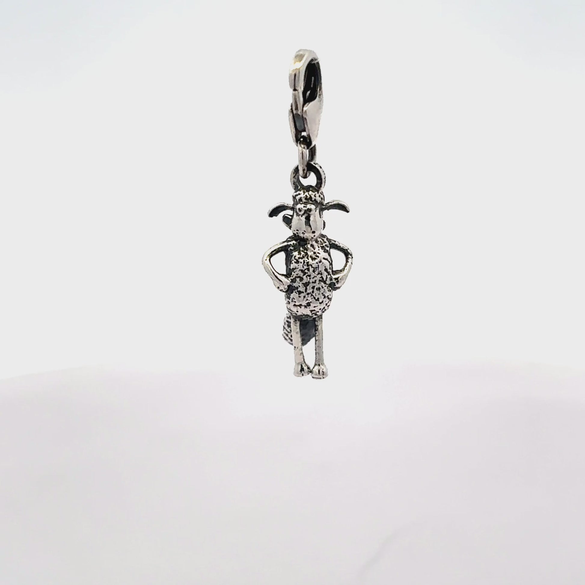 Angled view of Shaun the Sheep sterling silver clip-on charm highlighting sculpted character details