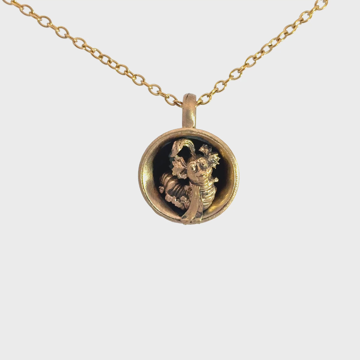 Video turnaround  showing the sculpted detail of the Labyrinth Worm in a Cup bronze necklace