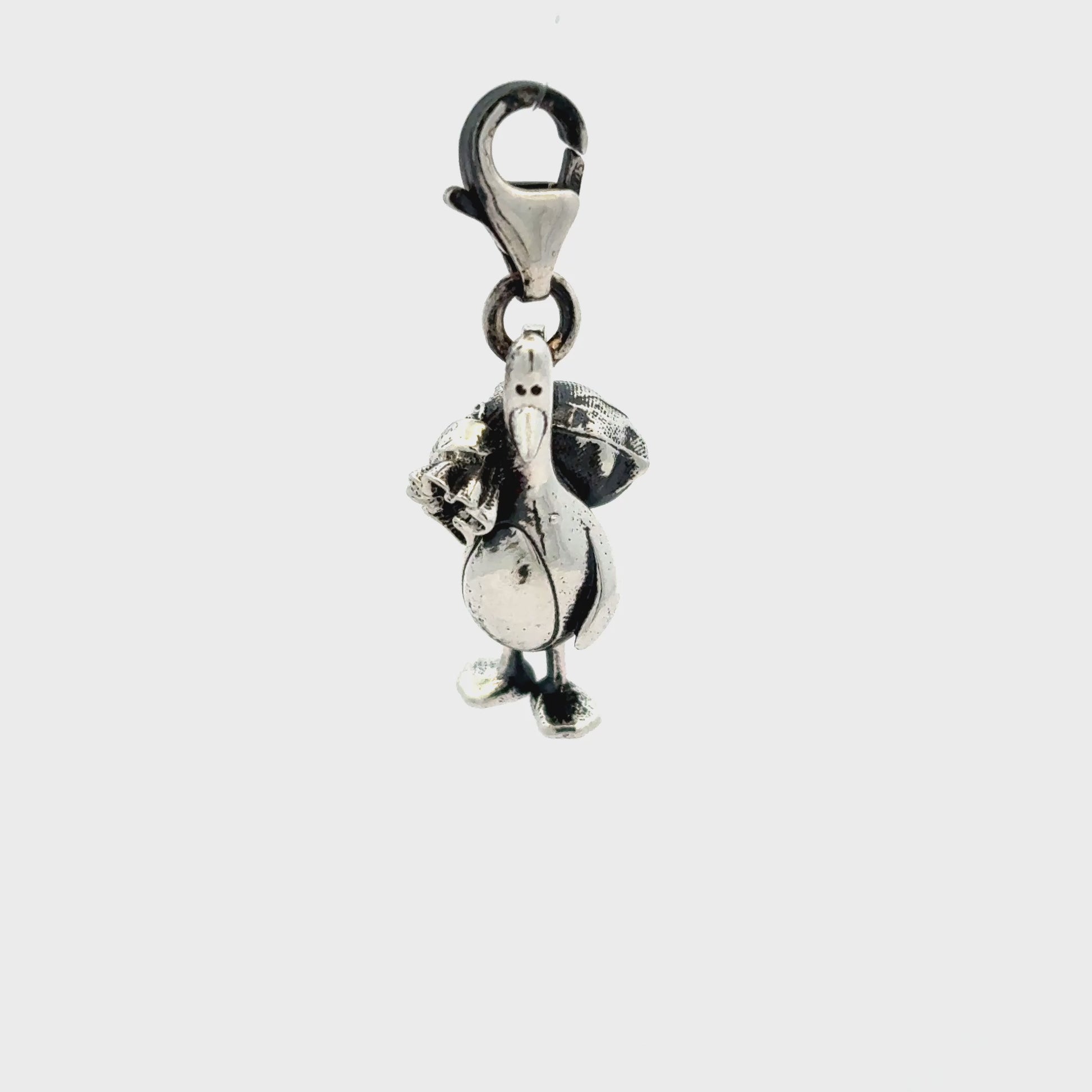 Detailed view of Feathers McGraw sterling silver charm showing oxidised finish and clip clasp