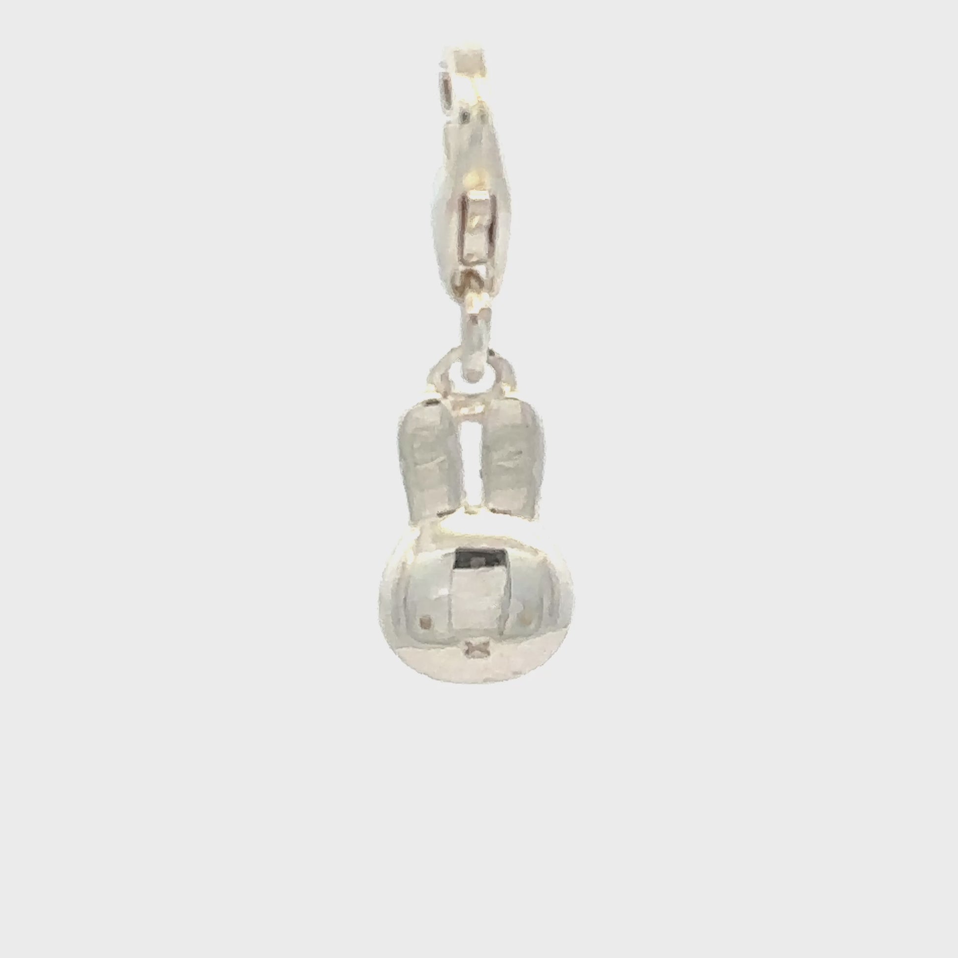 Sterling silver Miffy large head charm shown the charm turning around, highlighting smooth polished finish, on a white background.