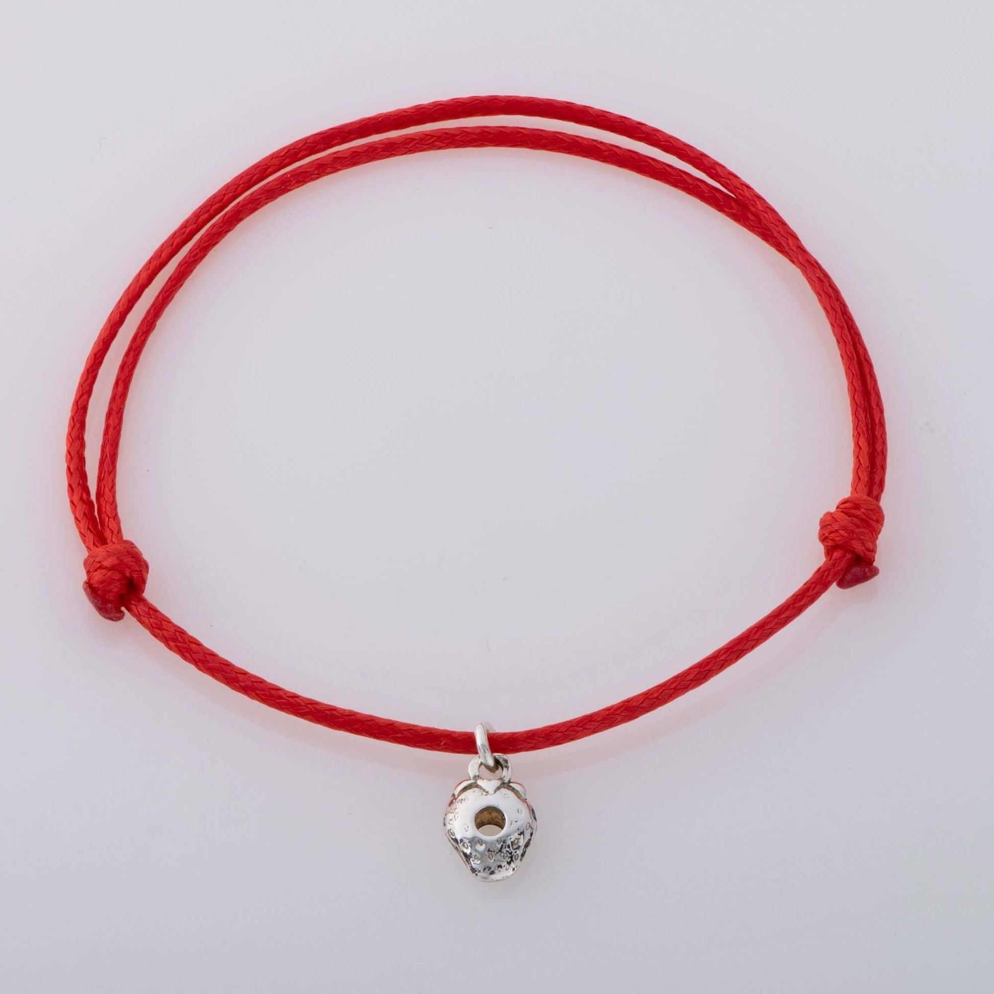 Sterling silver strawberry charm bracelet on a red adjustable cord, inspired by The Very Hungry Caterpillar. A perfect children's gift, handcrafted in the UK.